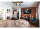 The bedroom features neutral tones, a window, dark wood accents, and a ceiling fan at 9293 Boltonia Ct, Las Vegas, NV 89149
