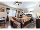 Relaxing bedroom featuring a window for natural light, ceiling fan, and dark wood accents at 9293 Boltonia Ct, Las Vegas, NV 89149