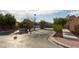 A well-manicured community entrance with lush landscaping and signage at 9293 Boltonia Ct, Las Vegas, NV 89149