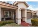 Inviting home exterior with a covered porch and a two-car garage at 9293 Boltonia Ct, Las Vegas, NV 89149