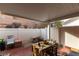 Enclosed patio area with partial covering, brick flooring, and privacy fencing at 9293 Boltonia Ct, Las Vegas, NV 89149