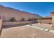 Low-maintenance backyard featuring decorative gravel, a paved walkway and secure block wall at 933 Monte Nerone Ave, Henderson, NV 89012