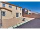Expansive backyard with gravel landscaping, block walls, and a sliding door for easy access to the home at 933 Monte Nerone Ave, Henderson, NV 89012