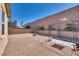 Desert landscaped backyard featuring gravel, custom stone pavers, metal gazebo, and mature trees at 933 Monte Nerone Ave, Henderson, NV 89012
