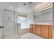 Bathroom with a glass enclosed shower, soaking tub, tile flooring, and a double sink vanity at 933 Monte Nerone Ave, Henderson, NV 89012