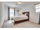 Bedroom with carpet flooring, a wood-framed bed, and two windows at 933 Monte Nerone Ave, Henderson, NV 89012