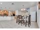 Open concept dining area features tile floors, a modern chandelier, and natural light at 933 Monte Nerone Ave, Henderson, NV 89012