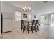 Open concept dining area features tile floors, a modern chandelier, and natural light at 933 Monte Nerone Ave, Henderson, NV 89012