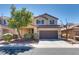 Beautiful two-story home with desert landscaping, complemented by a spacious two-car garage at 933 Monte Nerone Ave, Henderson, NV 89012