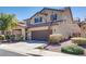 Two-story home with a well-maintained front yard and a convenient two-car garage at 933 Monte Nerone Ave, Henderson, NV 89012