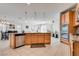 Kitchen with stainless steel appliances, updated backsplash, light wood cabinets, and island at 933 Monte Nerone Ave, Henderson, NV 89012