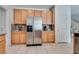 Bright kitchen features stainless steel refrigerator, ample cabinetry, and granite countertops at 933 Monte Nerone Ave, Henderson, NV 89012