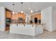 Open concept kitchen with stainless steel appliances, light wood cabinets, and a granite island at 933 Monte Nerone Ave, Henderson, NV 89012