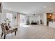 Bright living room with tile floors, sliding glass door, chair, and access to the kitchen at 933 Monte Nerone Ave, Henderson, NV 89012