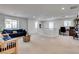 Bright living room with ample sunlight, neutral walls, comfortable seating, and a dedicated work space at 933 Monte Nerone Ave, Henderson, NV 89012