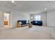 Spacious living room with neutral walls, plush carpeting, and comfortable seating for relaxing and entertaining at 933 Monte Nerone Ave, Henderson, NV 89012