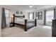 Bedroom featuring neutral paint, plush carpet, a large bed and two windows adorned with gray curtains at 933 Monte Nerone Ave, Henderson, NV 89012