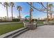 Scenic backyard with lush lawn, palm trees, and city views, creates a luxurious outdoor space at 1 Hughes Center Dr # 308, Las Vegas, NV 89169