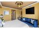 Cozy bedroom with a blue sofa, stylish decor, and ceiling fan at 1 Hughes Center Dr # 308, Las Vegas, NV 89169