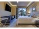 Bright bedroom featuring blue sofa, large window, and modern ceiling lights at 1 Hughes Center Dr # 308, Las Vegas, NV 89169