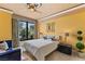 Bedroom featuring palm tree views, elegant decor, and a comfortable blue chaise at 1 Hughes Center Dr # 308, Las Vegas, NV 89169