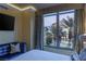 Bedroom with a large window view, blue sofa, and modern decor at 1 Hughes Center Dr # 308, Las Vegas, NV 89169