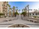 Beautiful courtyard features tall palm trees, manicured landscaping, and elegant seating areas for relaxation at 1 Hughes Center Dr # 308, Las Vegas, NV 89169