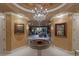 Elegant foyer showcasing a stunning chandelier, round table, and artwork, leading into the bright living area at 1 Hughes Center Dr # 308, Las Vegas, NV 89169