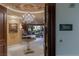 Elegant condo foyer features a crystal chandelier, round table, and an open view to the spacious living area at 1 Hughes Center Dr # 308, Las Vegas, NV 89169