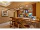 Gourmet kitchen features a breakfast bar with stone countertops, custom cabinets and professional appliances at 1 Hughes Center Dr # 308, Las Vegas, NV 89169