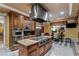 Gourmet kitchen with stainless steel appliances, granite countertops, custom cabinets, and a large center island at 1 Hughes Center Dr # 308, Las Vegas, NV 89169