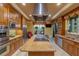 Gourmet kitchen with stainless steel appliances, granite countertops, custom cabinets, and a large center island at 1 Hughes Center Dr # 308, Las Vegas, NV 89169