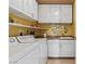 Functional laundry room with white cabinets, sink, and modern appliances at 1 Hughes Center Dr # 308, Las Vegas, NV 89169