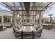 Inviting outdoor dining area features a pergola, elegant seating, and a fireplace, ideal for gatherings at 1 Hughes Center Dr # 308, Las Vegas, NV 89169