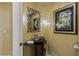 Elegant powder room features unique vessel sink, ornate mirror and sconces, and neutral color palette at 1 Hughes Center Dr # 308, Las Vegas, NV 89169