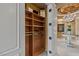 Spacious walk-in closet with custom built-in shelves, adjacent to a decorative hall with chandelier at 1 Hughes Center Dr # 308, Las Vegas, NV 89169