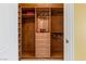 Spacious wooden walk-in closet with multiple shelves, drawers, and hanging rods offers ample storage solutions at 1 Hughes Center Dr # 308, Las Vegas, NV 89169