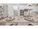 Well-lit kitchen with white cabinets, granite countertops, and a view of the walk-in pantry at 106 Reflection Bay Dr, Henderson, NV 89011