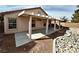 Relax under a covered patio overlooking a rock feature landscaping feature in the private backyard at 11036 Parete Ct, Las Vegas, NV 89141