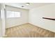 Empty bedroom features neutral carpet and a window for natural light at 11036 Parete Ct, Las Vegas, NV 89141