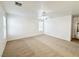 A bright empty bedroom with neutral-toned carpet, ceiling fan, and natural light at 11036 Parete Ct, Las Vegas, NV 89141