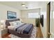 This virtually staged bedroom has hardwood floors and a queen bed at 11036 Parete Ct, Las Vegas, NV 89141
