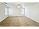 Empty bedroom features neutral carpet, a ceiling fan, and bright natural light at 11036 Parete Ct, Las Vegas, NV 89141