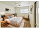 Virtually staged bedroom with a bed, nightstand, and chair at 11036 Parete Ct, Las Vegas, NV 89141