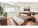 Virtual staging depicts a modern bedroom design with wooden furnishings and decor at 11036 Parete Ct, Las Vegas, NV 89141