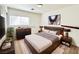 This virtually staged bedroom features a queen bed, nightstands, and artwork at 11036 Parete Ct, Las Vegas, NV 89141