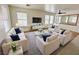 Bright living room with white sofas, plush rug, and a decorative mirror at 11036 Parete Ct, Las Vegas, NV 89141