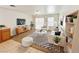 Inviting living room with striped rug, white sofa, and a decorative shelving unit at 11036 Parete Ct, Las Vegas, NV 89141