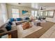 Inviting living room with a large sectional sofa and a modern coffee table at 11036 Parete Ct, Las Vegas, NV 89141