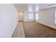 Bright living room with plush carpet, two windows, and tiled entryway at 11036 Parete Ct, Las Vegas, NV 89141